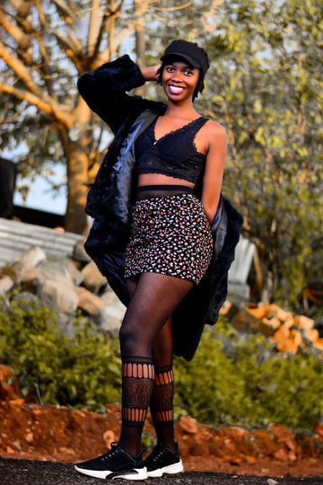Fishnet stay up stockings worn with shorts and a jacket for an autumn street style look
