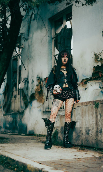 Goth leg warmers styling with a dark layered outfit, fishnets and tall platform boots