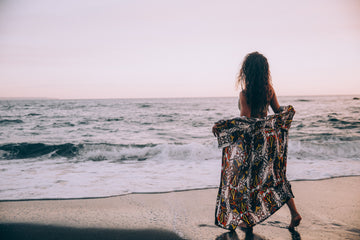 Plus size woman in flowing sarong on a tropical beach, a stunning plus size cruise resort wear moment.