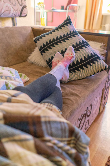 Person resting with legs up after a long day, relieved by comfortable support