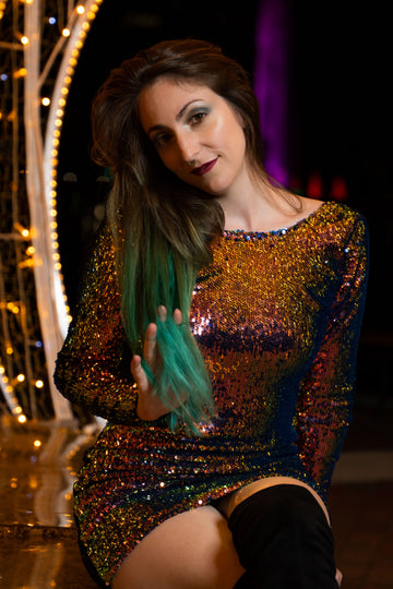 Plus size sequin holiday party outfit with shimmering sequin dress sparkling under festive lights