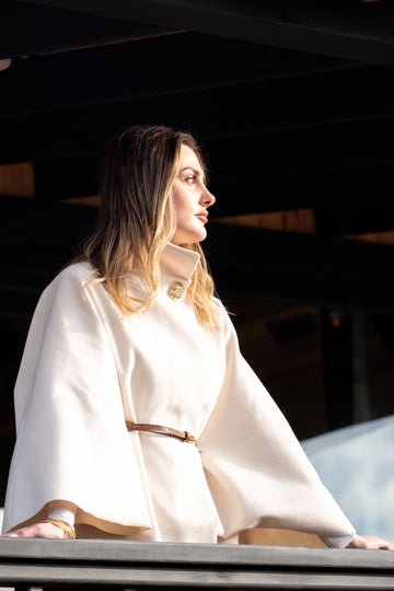 Plus size woman wearing an elegant white cape coat for fall outerwear styling