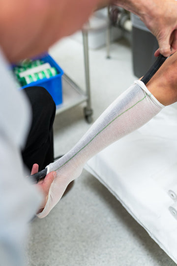 Clinician measuring a patient's calf to select the correct compression socks level for plus size legs