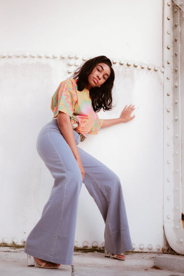Plus-size woman in bell-bottom jeans posing for a casual bootcut denim look