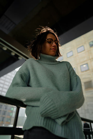 plus size woman in gray turtleneck sweater styled for fall