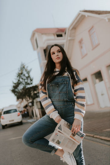 Woman wearing plus size dungarees denim overalls on a relaxed city street