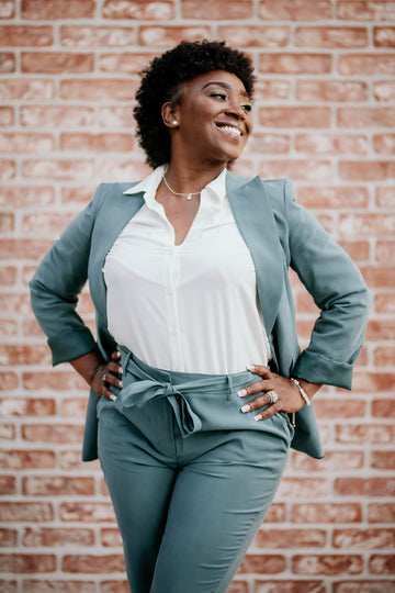 Plus size interview outfit with a confident curvy woman in a tailored teal suit