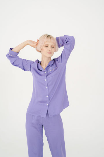 Woman in a soft purple pajama set ready for a cozy night in