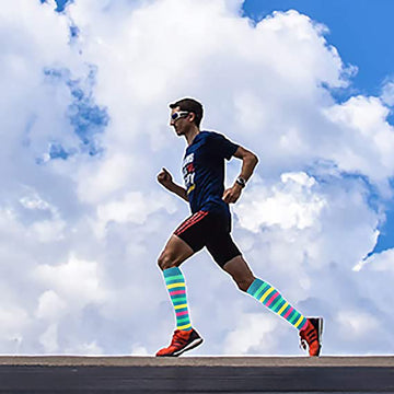 Multicolor striped compression socks on a running person