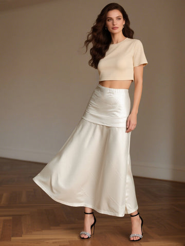 Ivory satin maxi skirt with elastic waistband and layered flounce hemline.