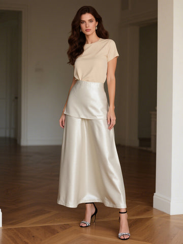 Cream satin maxi skirt with elastic waistband and layered ruffle hem.