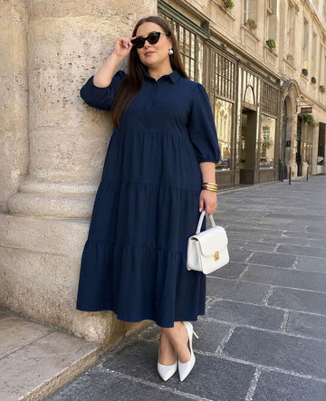 Navy tiered shirt dress with collared neck and belted waist