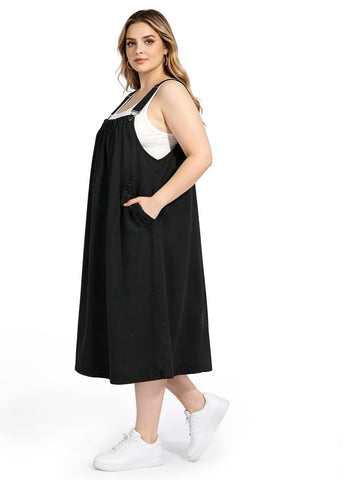 Plus size black denim overall dress with smocked bib and wide shoulder straps