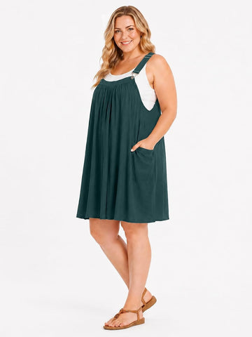 Plus size green overall sundress with adjustable straps and pleated knee-length skirt