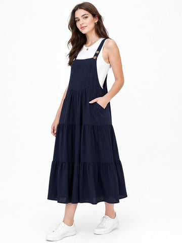Navy sleeveless tiered midi overall dress with adjustable cross-back straps
