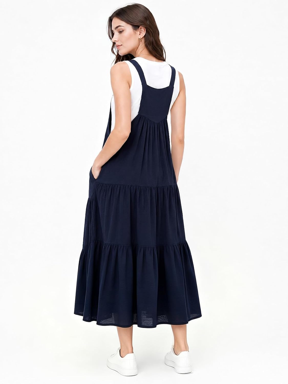 Navy tiered midi overall dress with scoop neckline and crossed back straps
