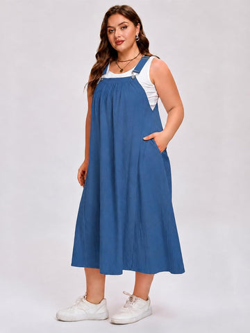 Blue sleeveless A-line overall dress with adjustable straps and front pockets