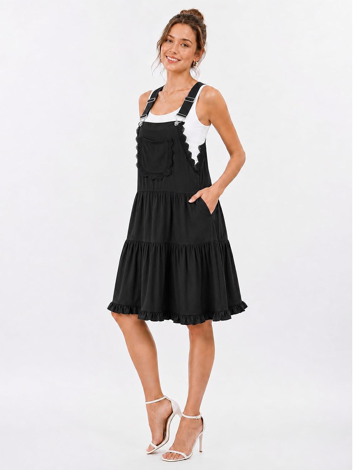 Black overall dress with lace-trim bib front, tiered skirt, and adjustable shoulder straps