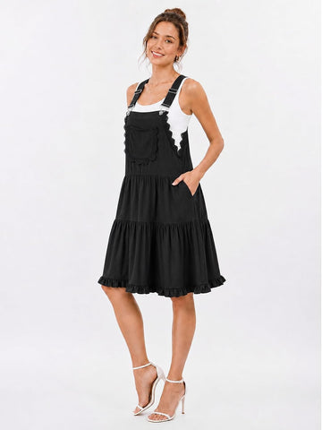Black overall dress with lace-trim bib front, tiered skirt, and adjustable shoulder straps