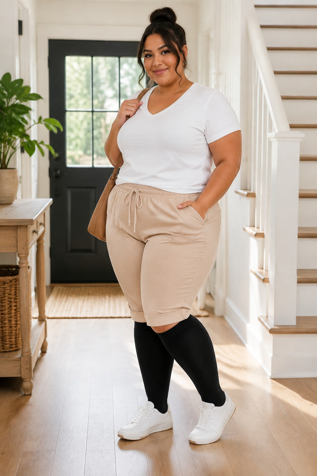 Plus size extra wide black compression socks worn on a fuller figure in a home entryway
