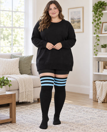 Plus Size Thigh High Socks Striped - Black & Blue plus size woman wearing extra-long thigh high socks in a indoor lifestyle scene, upper-thigh length, original knit texture preserved
